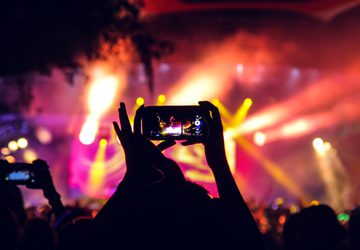 People at a concert taking pictures with phones