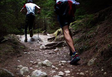 Two people running on a trail