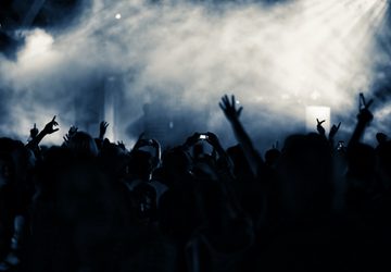 Grey and blue smoke over crowd at nightclub