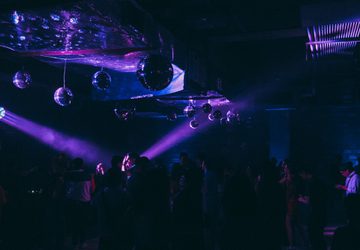 People dancing in purple club