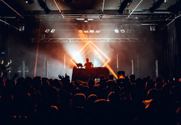 DJ performing in front of a crowd in a club