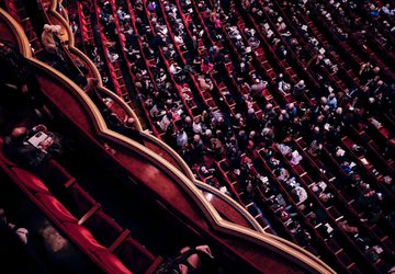 Audience sitting in a performance theatre