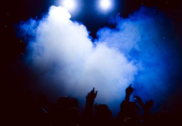 People with arms in the air in a club