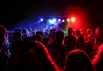 Crowd dancing in multicolour lights