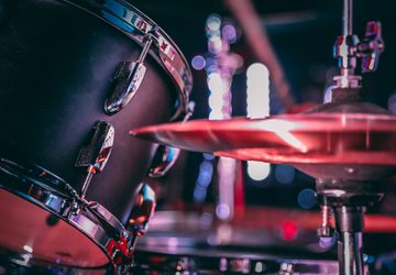 Black acoustic drum set with shiny hi hat