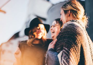 Three people laughing together