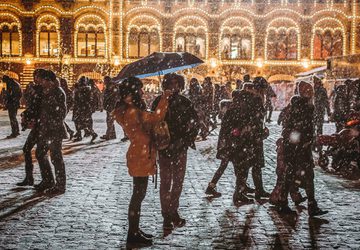 Busy and snowy cobbled street