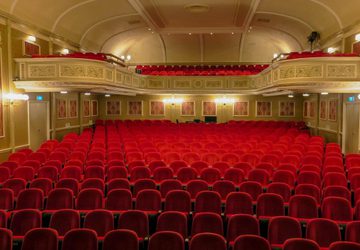 Empty red seats in a theatre