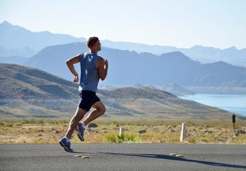 Person running on a scenic road